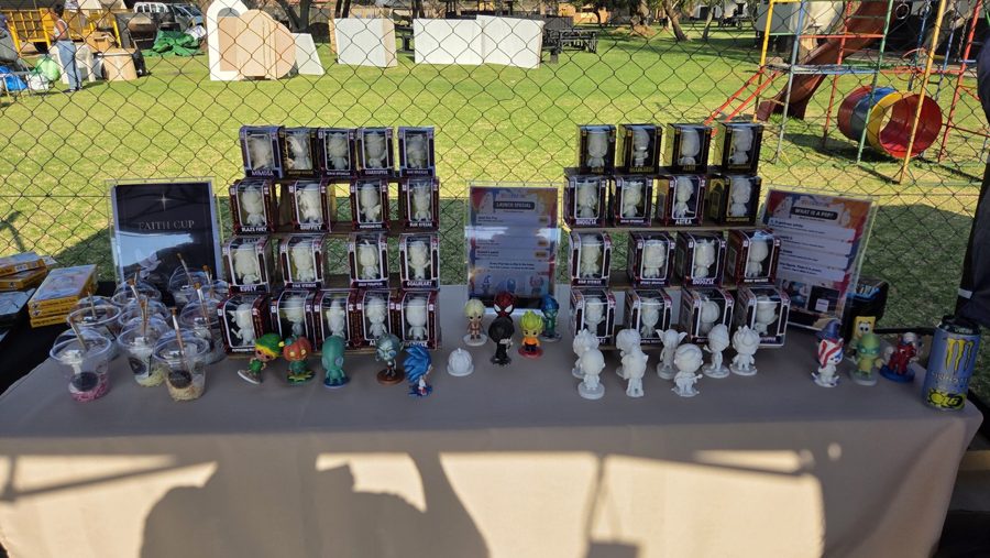 The ColourPops stand set up at a market, boxed Pops, paints and painted figures