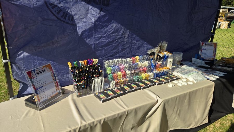 Racks of paint pots, pens and brushes on the paint table
